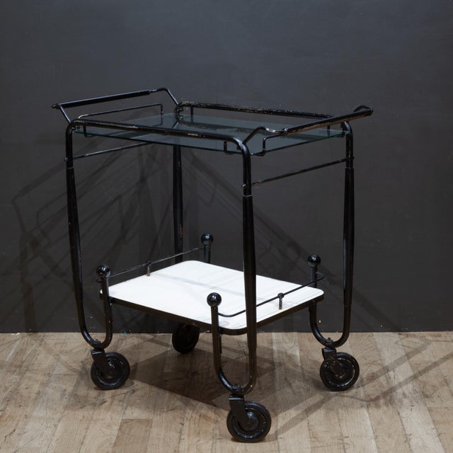 ABOUT Mid-century rolling bar cart with glass top shelf and lower Formica shelf. CREATOR Unknown. DATE OF MANUFACTURE...