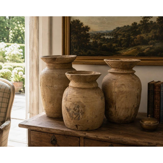 A striking set of three antique hand-turned wooden vessels with a beautifully bleached, raw surface and quiet sculptural...