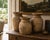 A striking set of three antique hand-turned wooden vessels with a beautifully bleached, raw surface and quiet sculptural...