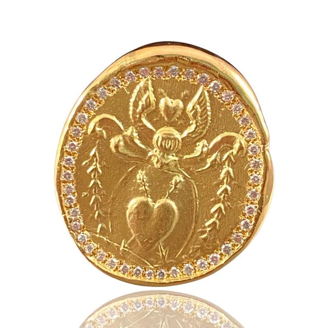 ‘Angel Heart’ ring in 18k gold features two hearts combined with Angel wings which embody love, miracles and guided...