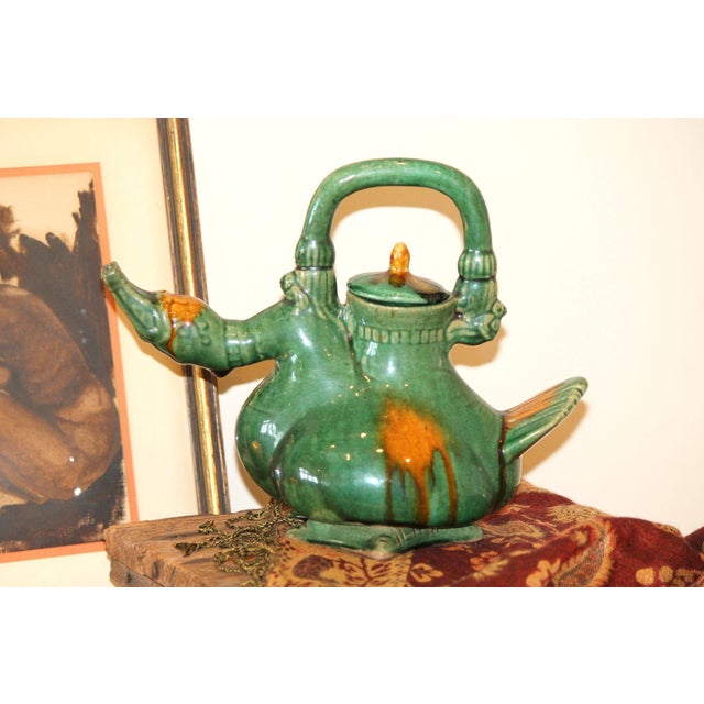 This gorgeous teapot is complete with the original lid and no damage! Painted a shade of green with dark goldenrod...