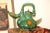 This gorgeous teapot is complete with the original lid and no damage! Painted a shade of green with dark goldenrod...