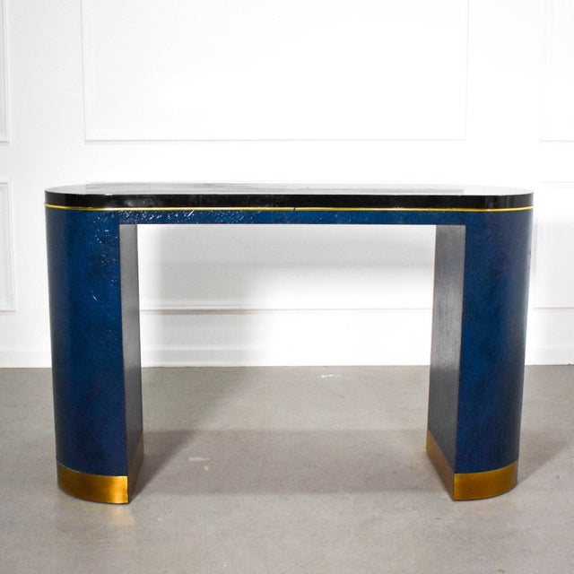 Sculptural Egyptian blue faux wrapped snakeskin and brass console table attributed to Karl Springer. A great example of...