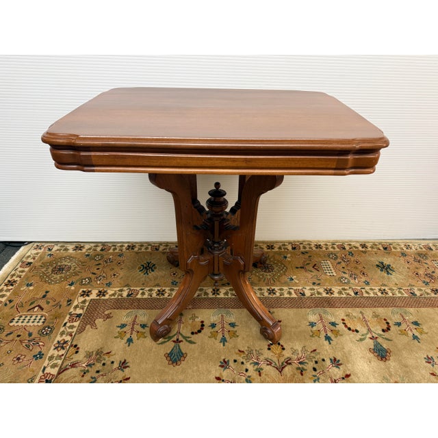Design Plus Gallery presents a 19th Century Walnut Side Table. The antique Eastlake Victorian parlor table was constructed...