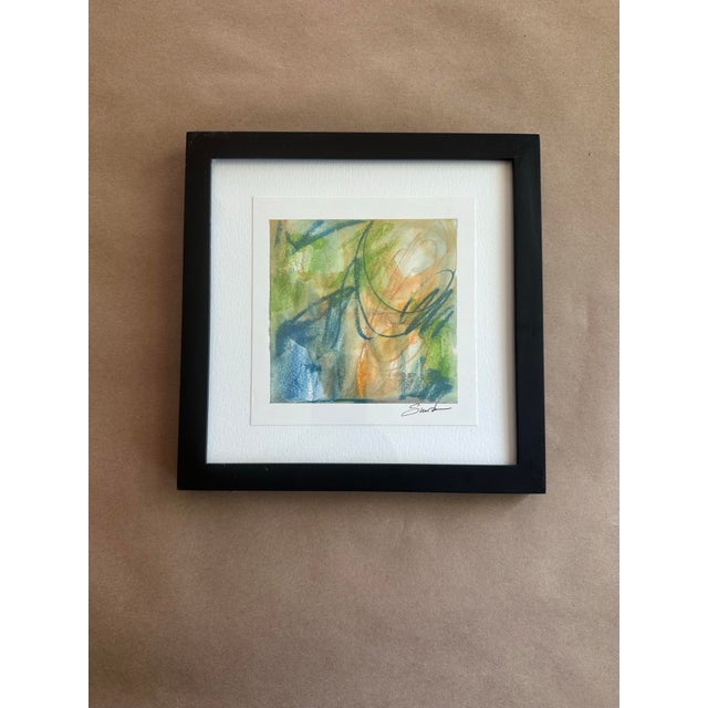 An expressive abstract watercolor layered with fluid washes of sage green, sky blue, and warm apricot tones. Energetic...