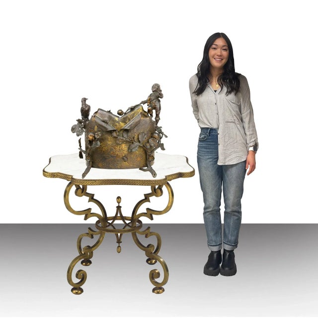 A Gilt & Patinated Bronze Figural Jardiniere, Austria, 19th Century. The body of the jardiniere is uniquely designed with...