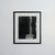 Vintage abstract monochrome work in deep black and gray tones, presented in a black wood frame with a wide white mat.
