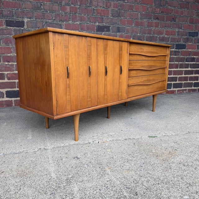 American-made mid-century modern long lowboy dresser with a distinctly Scandinavian-inspired feel. The design is clean and...