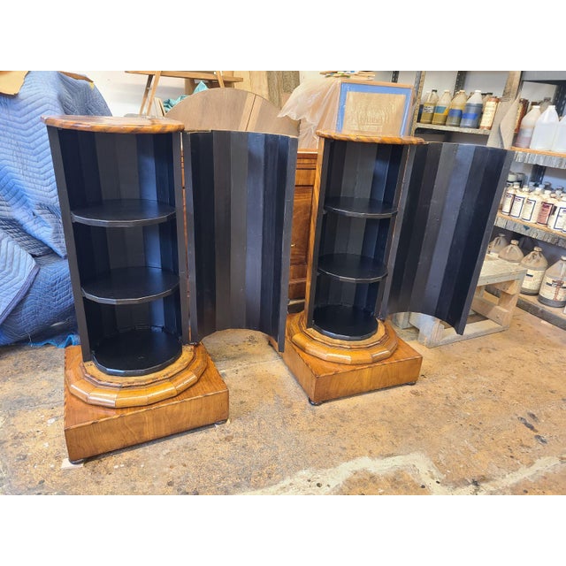 These pieces are veneered in alternating walnut and fruitwood and have been fully restored. The interiors feature a new...