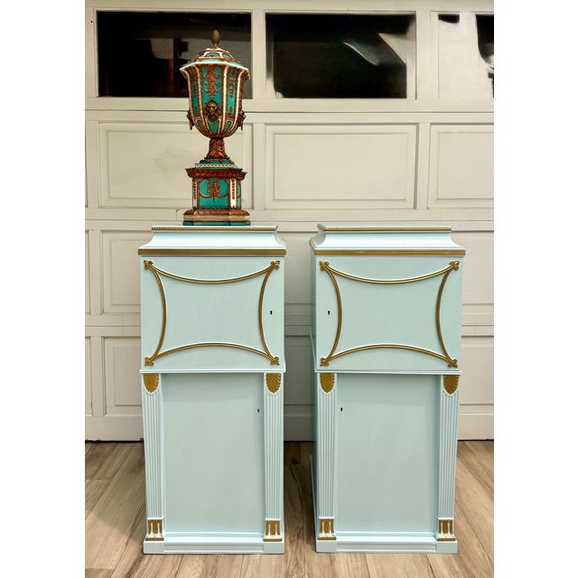 This striking pair of antique pedestal cabinets has been newly refinished in a beautiful satin, robin’s egg blue with...