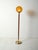 Scandinavian floor lamp from the 1960s with a teak stem, brass base, and a blown amber glass globe. Elegant Scandinavian...