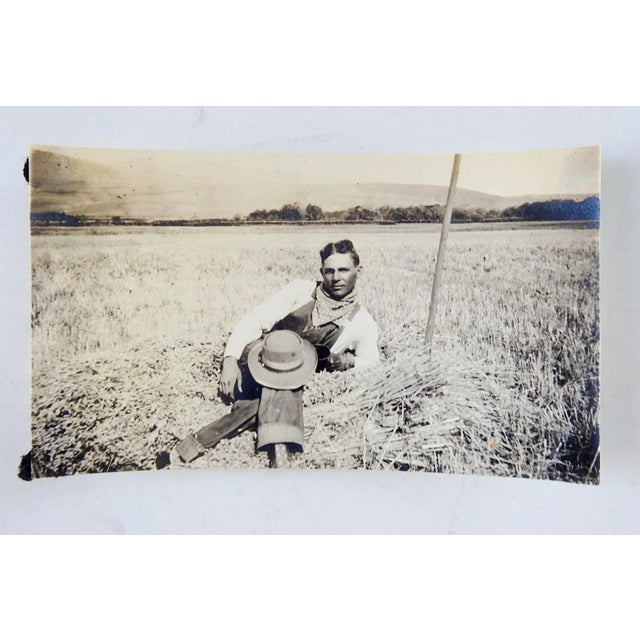 Vintage circa 1915 sepia tone snapshot photograph of handsome farmer. Reclining in a field in his overalls, posing for the...