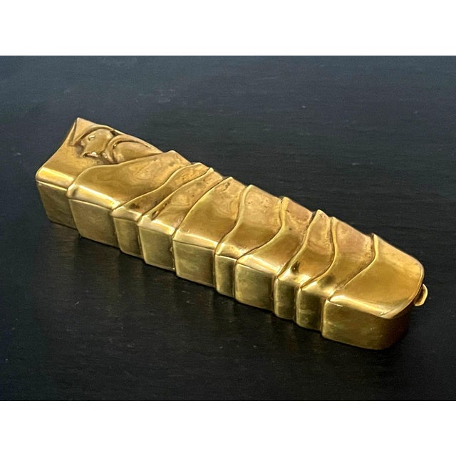 A rare cast gilt bronze box "Pinocchio" by French Parisian art jeweler Line Vautrin (1913-1997). The elongated lidded box...