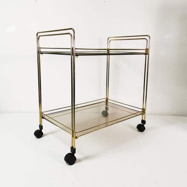 This bar originated in Germany in the 1970s. It features a minimalist, modern design. Made of metal with tinted glass...