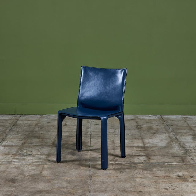 The iconic chair designed by Mario Bellini for Cassina c.1970s, Italy, features the original navy blue saddle leather...