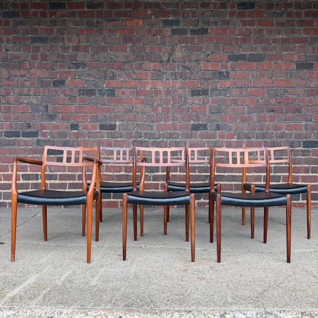 This is a gorgeous set of 6 Danish modern, rosewood and vinyl dining chairs made by J.L. Møller. This Model 79 chair was...