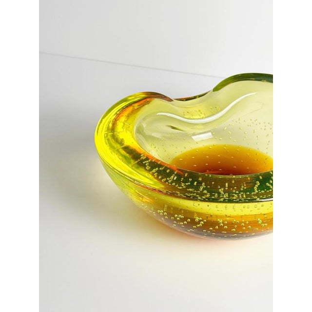 This Murano uranium glass bowl by Galliano Ferro was produced in Italy during the mid-twentieth century and exemplifies...