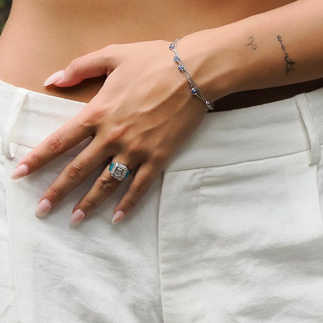 The Sterling Silver Pave Diamond & Turquoise Enamel Ring is a testament to the fusion of vibrant aesthetics and timeless...