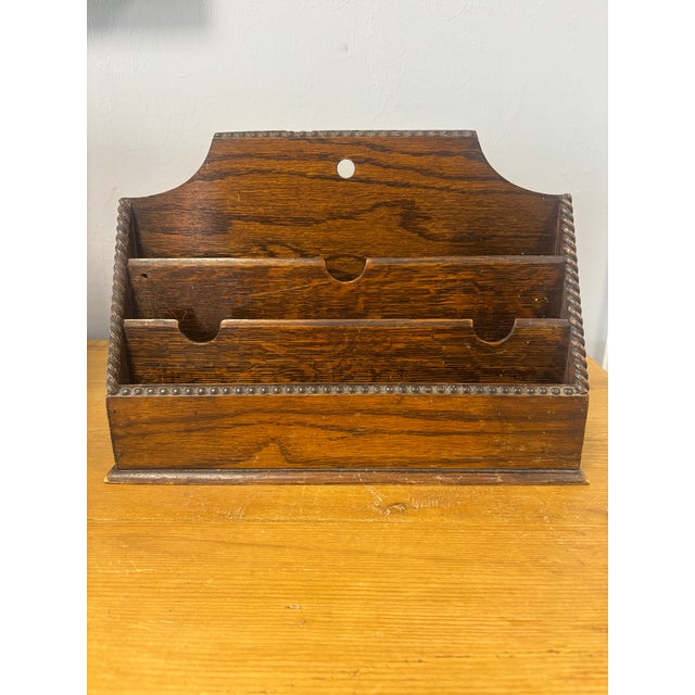 A charming example of English craftsmanship, this antique letter rack is fashioned from oak, with a rich, time-worn patina...