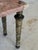 Elegant neoclassical-style table featuring a softly veined pink marble top supported by finely detailed gilt metal legs....