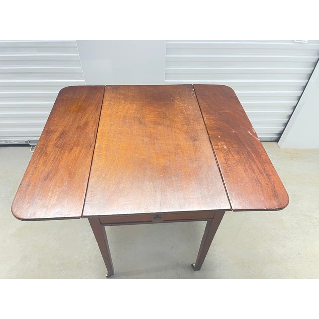 Antique English mahogany Pembroke table. Drop leaves, original brass.