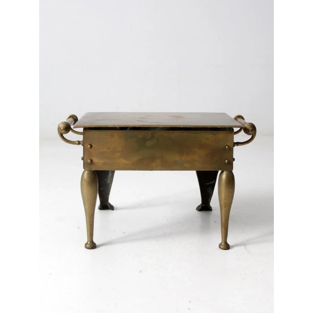 This antique brass fireplace footman was traditionally used to keep dishes warm by the hearth in a kitchen or dining room....