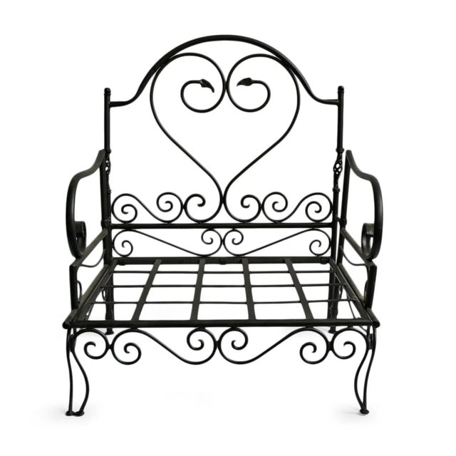 Beautifully crafted vintage iron scroll arm chair featuring graceful hand-forged curves and a striking heart-form back,...