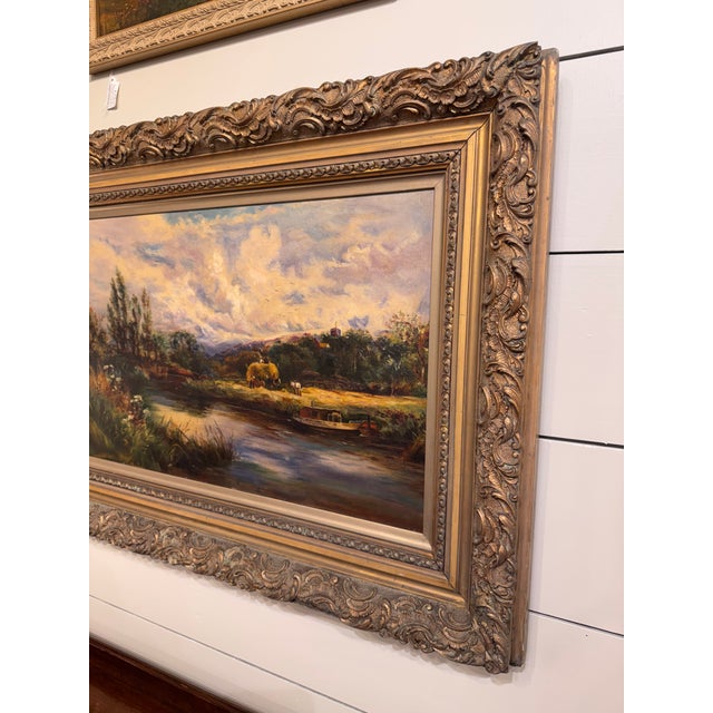 English School 1908 Oil - "Over the River" This tranquil early 20th-century riverside scene features lush vegetation,...
