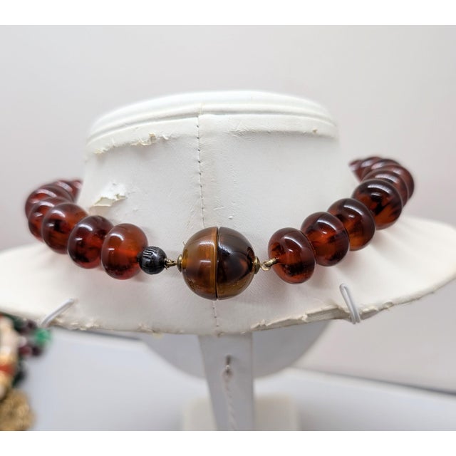 1980s goldtone with resin faux-tortoise ellipsoid beads with magnetic clasp and a silvertone bead next to the clasp...