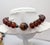 1980s goldtone with resin faux-tortoise ellipsoid beads with magnetic clasp and a silvertone bead next to the clasp...