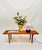 This minimalist design side table or flower bench with wooden slats in walnut shows a beautiful wood grain in warm tones....
