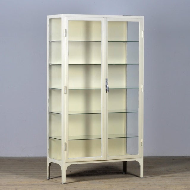 Medicine cabinet from the 1930s. Produced in Hungary, it is made of thick iron and the original antique glass. It features...