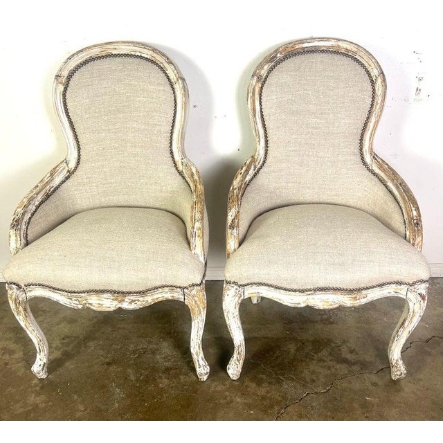 Pair of 19th century chairs with an elegant, curved design typical of French Provincial style furniture. They feature...
