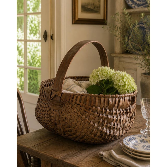 A generously scaled late-19th-century gathering basket, handwoven from narrow oak splints around a sturdy fixed bentwood...