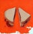 This artwork depicts a simple yet evocative representation of a peanut butter and jelly sandwich, cut in half and placed...