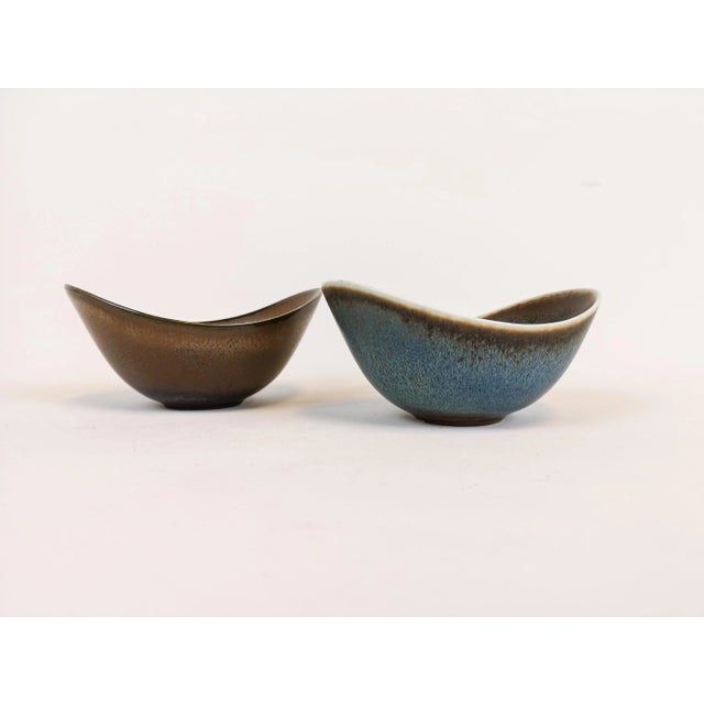 This pair of bowls was designed by by Gunnar Nylund and produced by Rörstrand in Sweden during the 1950s. They both...