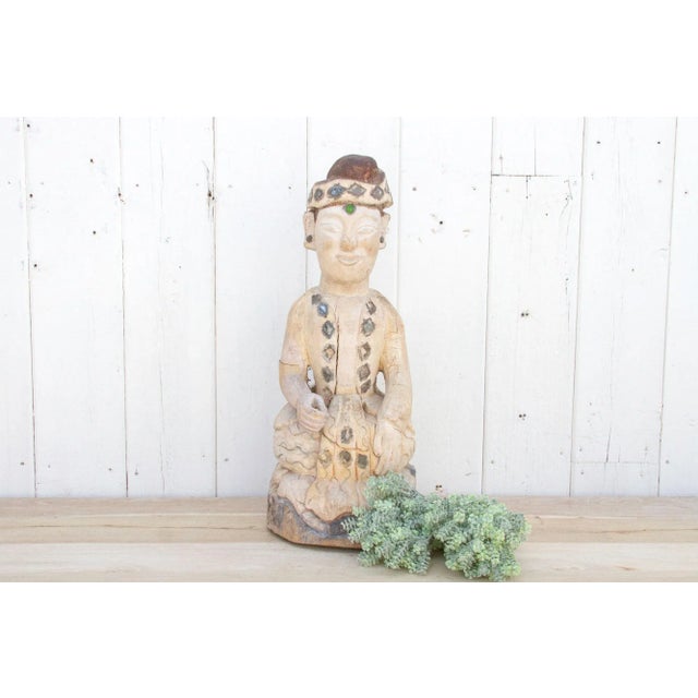 A magnificent Buddha statue found in Myanmar. It is a hand-carved from a single teak wooden log and is adorned with...