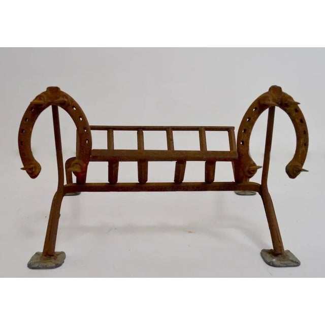 Folky Blacksmith made fireplace log holder grate with horseshoe mounted on the front as decoration. Unique handmade item...