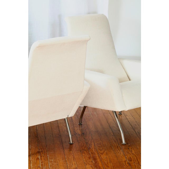 Pair of Italian mid-century lounge chairs, circa 1960s, newly reupholstered in a cream flat weave fabric. Sculptural...