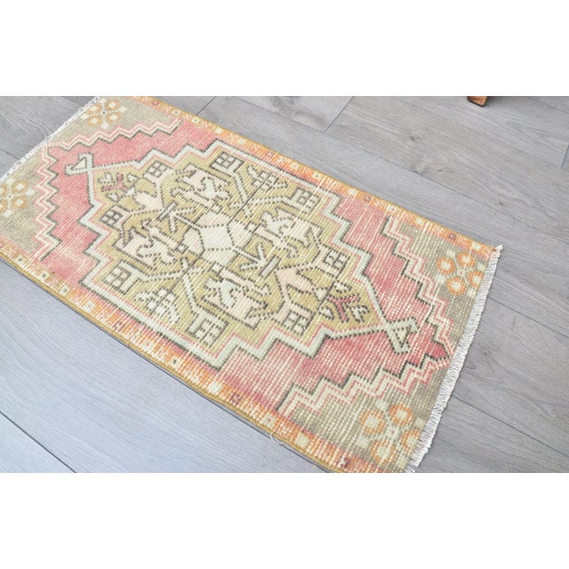 This is a vintage Turkish Oushak rug from the 1960s. The piece was hand-knotted.