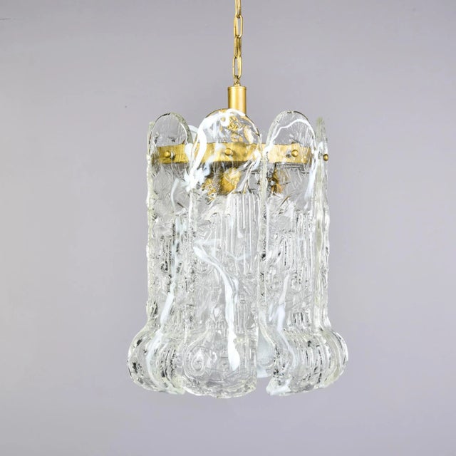 Found in Italy, this hanging Murano glass pendant fixture attributed to Mazzega dates from the early 1970s. This fixture...