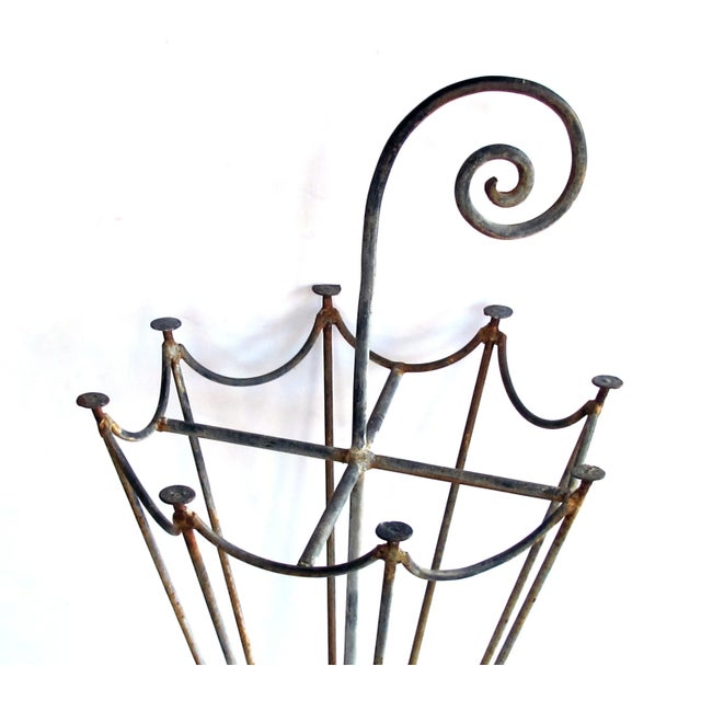 with scrolling handle and openwork body over a tripod base