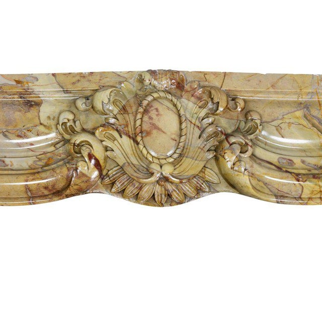 With shaped rectangular top over a shaped lintel with central cabochon cartouche raised on shaped supports. Provenance:...
