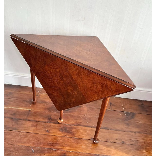 A finely crafted corner drop-leaf “handkerchief” table by Heckman Furniture, inspired by Colonial Williamsburg and Queen...