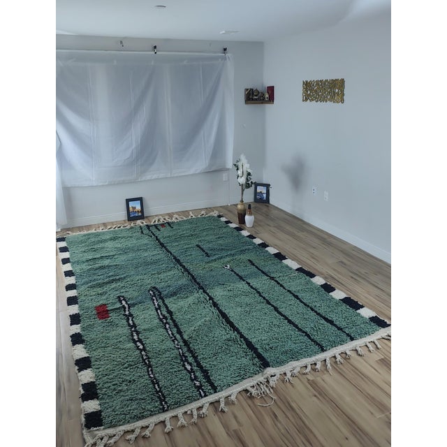 One-of-a-kind handwoven contemporary Moroccan rug. Woven in deep forest green, its field crossed by free-form black line...