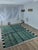 One-of-a-kind handwoven contemporary Moroccan rug. Woven in deep forest green, its field crossed by free-form black line...