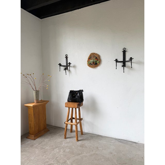 Pair of antique wrought iron wall sconces in a Brutalist style. Dating from the early 20th century, these sconces are...