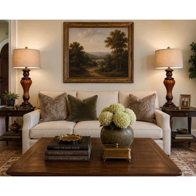 A dramatic pair of Neoclassical Revival table lamps featuring carved architectural forms, warm faux walnut finishes, and...