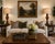 A dramatic pair of Neoclassical Revival table lamps featuring carved architectural forms, warm faux walnut finishes, and...