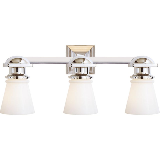 New York Subway Triple Light in Polished Nickel with White Glass Designer: Chapman & Myers Height: 9.75" Extension: 8"...